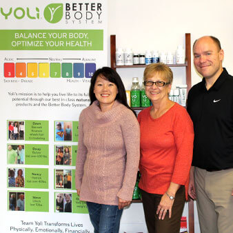 The staff of Montgomery Family Chiropractic standing in front of the nutritional supplement display inside their office